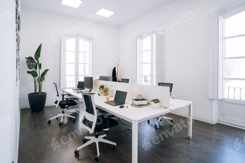 Preview: Modern coworking space with shared desks and natural light illuminating the room