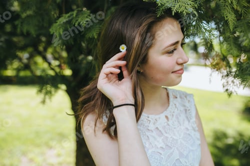 Preview: Beautiful young girl smiling in the park. healthy new life image
