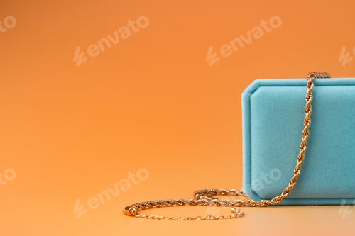 Preview: Blue jewelry box on yellow background close up