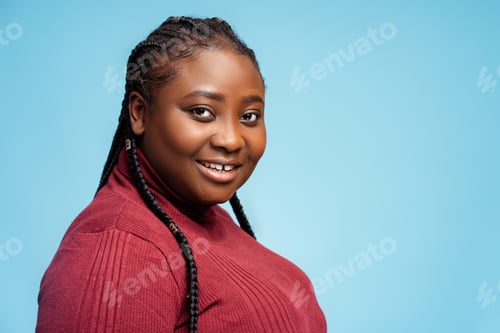 Preview: Happy, smiling African American woman wearing stylish casual red sweater looking at camera