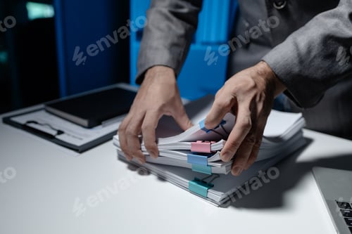 Preview: An employee held a large pile of documents in his hand, Large piles of work documents on desks are b