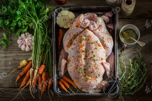 Preview: Ingredients for roasted homemade chicken with garlic and carrots