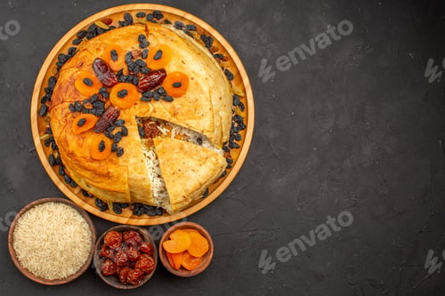 Preview: top view shakh plov delicious rice meal cooked inside round dough with raisins on grey background