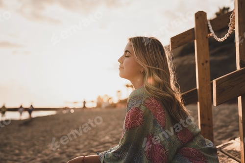 Preview: Portrait of one young woman at the beach with closed eyes enjoying free time