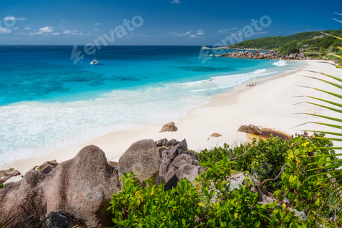 Preview: Petite Anse, La Digue in Seychelles - Tropical and paradise beach. Yacht boat at anchor in blue