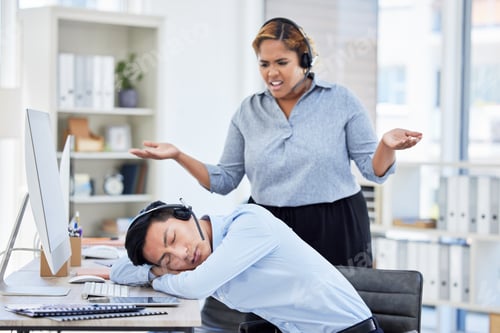 Preview: Close up of young asian businessman feeling tired and sleeping on the desk of a call center in a of
