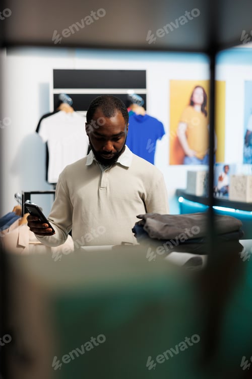 Preview: Man checking price online in store