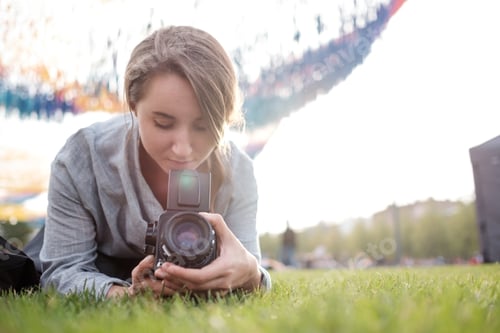 Preview: Woman making photo on retro camera