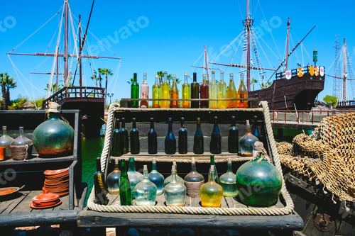 Preview: Old glass bottles in a display of a medieval market.