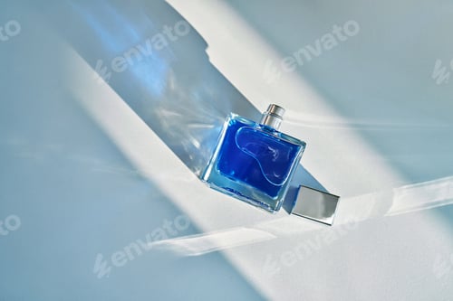 Preview: Blue fragrance bottle creating light and shadow patterns