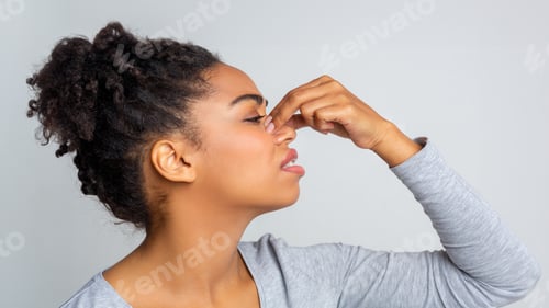 Preview: Side view of woman touching her nose