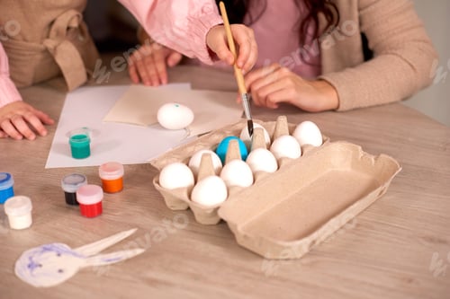 Preview: Happy easter! Happy family preparing for Easter. Closeup brush for drawing in girl's hands