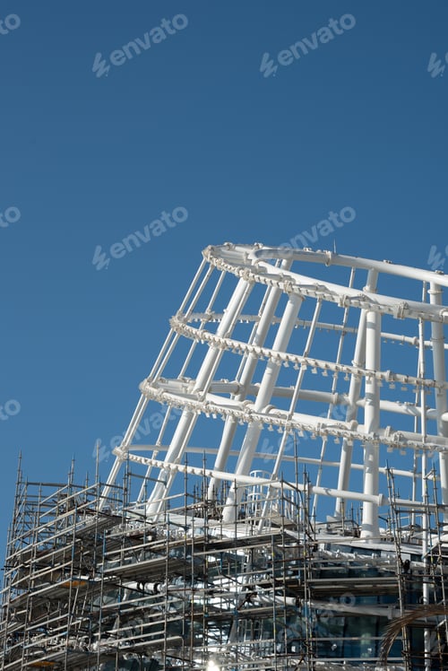 Preview: Residential office building construction site and cranes during a vibrant summer day with blue sky