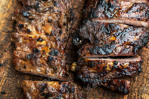 Preview: Barbeque spare ribs on wooden cutting board, grilled and smoked pork rib.