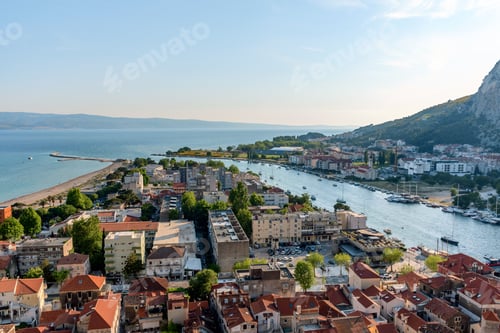 Preview: Aerial view of cityscape Omis surrounded by buildings and Cetina river
