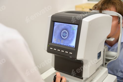 Preview: the optometrist controls the oculist display with the scanned eyes of the man, diagnostic