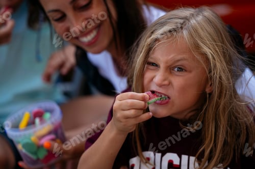 Preview: Family eating candy on a happy picnic.