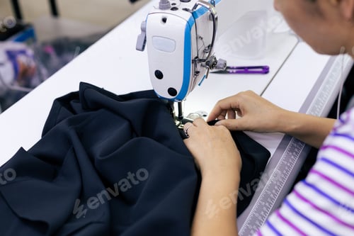 Preview: Tailor working on electric sewing machine
