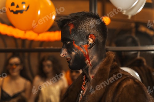 Preview: Halloween party with friends in a disco nightclub, portrait of a man in costume with painted bed