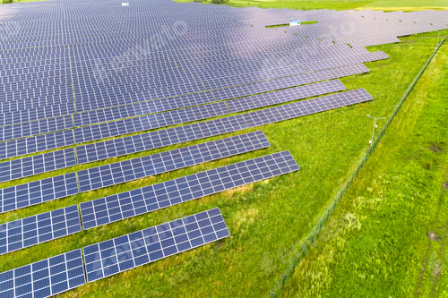 Preview: Aerial view of solar power plant on green field.