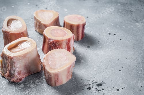 Preview: Raw calf Marrow bones on butcher table. Gray background. Top view. Copy space