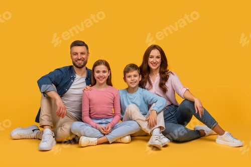Preview: Family Posing for Picture on Floor Over Yellow Background