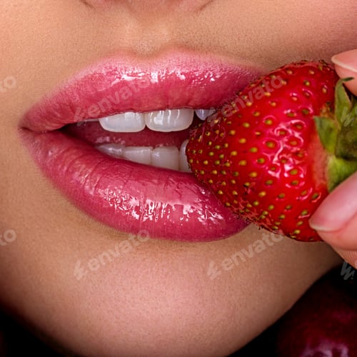 Preview: Close-up of a woman's mouth biting strawberries. Girl's lips and strawberries