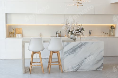 Preview: Kitchen with white interior, table in the middle, with silver Christmas decorations