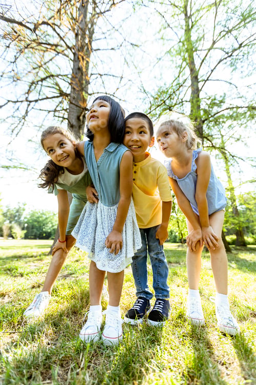 Preview: Group of asian and caucasian kids having fun in the park