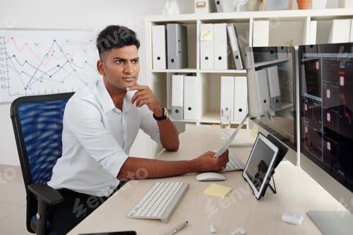 Preview: Trader monitoring stock market