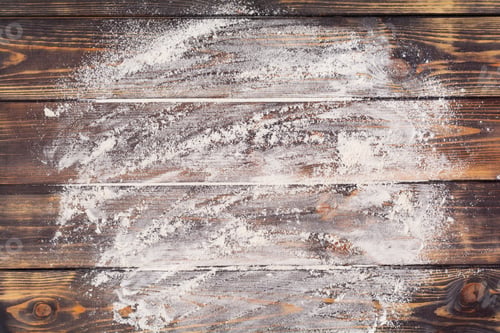 Preview: Flour scattered in the form of a circle, rolling pin and white linen napkin on an old wooden backgro