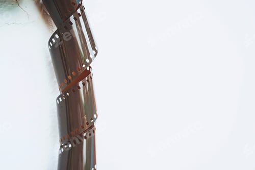 Vista previa: Minimal image of a old film roll against white background
