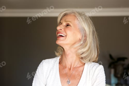 Preview: laughing older woman standing inside home
