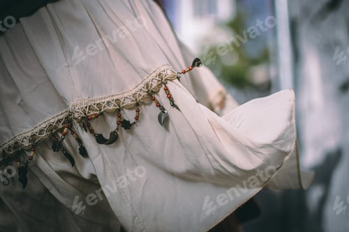 Preview: Closeup shot of a milk-white dress with a beautiful ethnic design