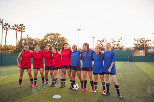 Preview: Womens Football Team Hugging After Training For Soccer Match On Outdoor Astro Turf Pitch