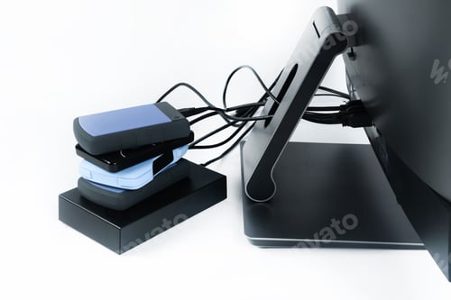 Preview: Multiple external hard drives connected to a monoblock on a white background.Computer with hard