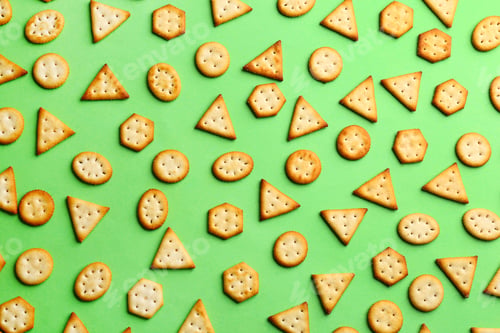 Preview: Delicious crackers on light green background, flat lay