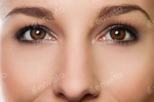 Preview: Cropped studio portrait of young woman's eyes