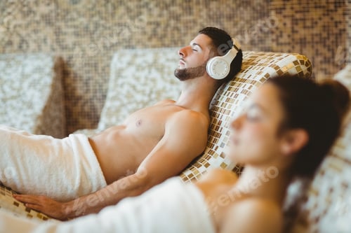 Preview: Man and woman lying down together at the spa