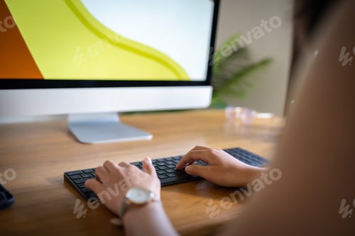 Preview: Graphic designer working on digital tablet and computer.