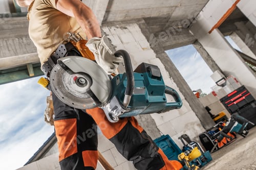 Preview: Construction Worker with a Professional Circular Saw in His Hand