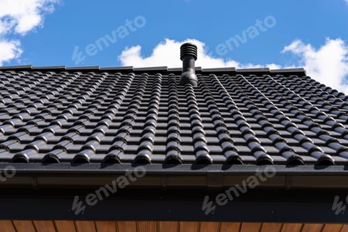 Preview: Dark tiled roof providing building ventilation against blue sky