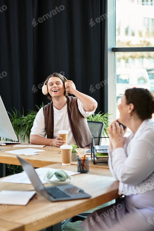 Preview: Young plus size woman and her friend laughing together in a cozy office environment