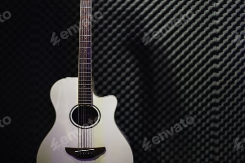 Preview: Accoustic string guitar on studio wall