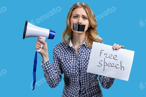 Preview: Woman with taped mouth holding loudspeaker and banner with free speech inscription.