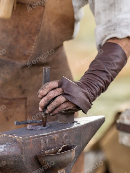 Preview: blacksmith works outdoors. Makes a horseshoe with tools