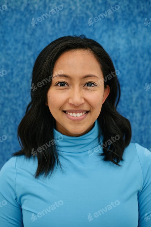 Preview: Young business woman smiling wearing blue turtleneck on blue background