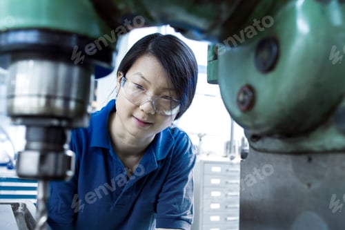 Preview: Young woman working in industrial workshop