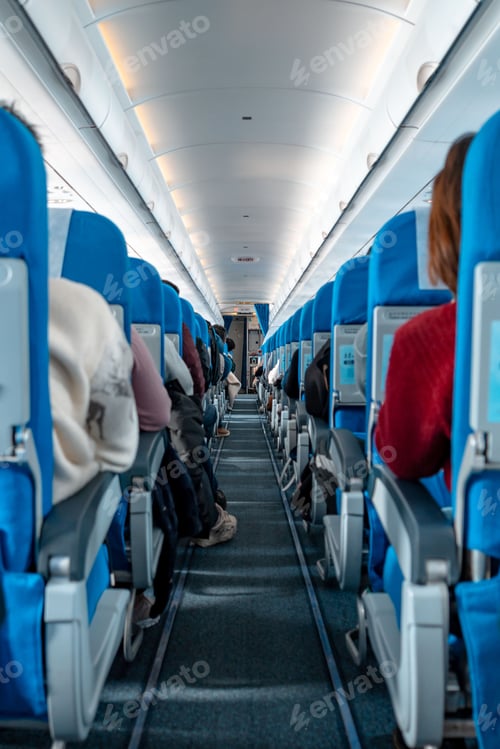 Preview: Aircraft cabin with rows of seats down the aisle