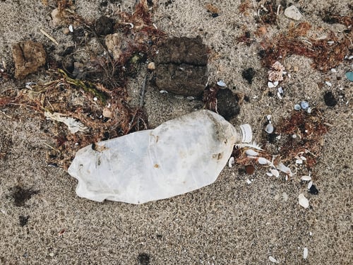 Preview: Single use plastic bottle in sand, marine trash on the beach